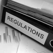 Regulations Folder on Cluttered Desk 