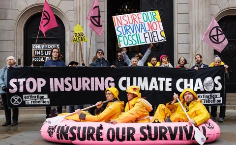 Extinction rebellion protesters sitting in a pink dinghy 
