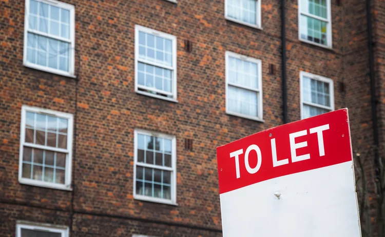 To Let sign with council housing flats at Rockingham estate in the background around Elephant and Castle area in south London