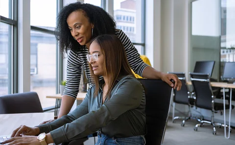 Senior colleague mentoring a young employee in the office