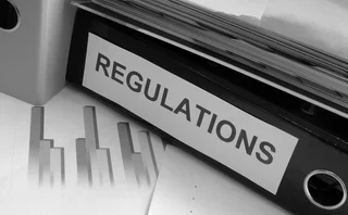 Regulations Folder on Cluttered Desk 