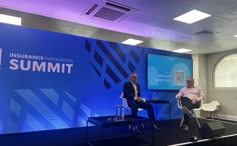 Perry Thomas sat to the left on stage at Insurance Innovators Summit