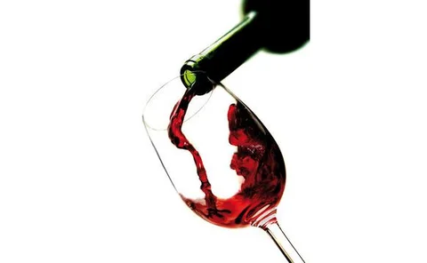 Red wine pouring into glass