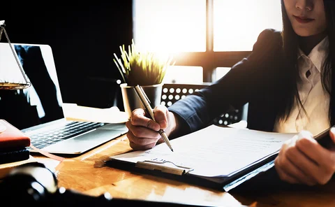 Woman underwriting insurance in office